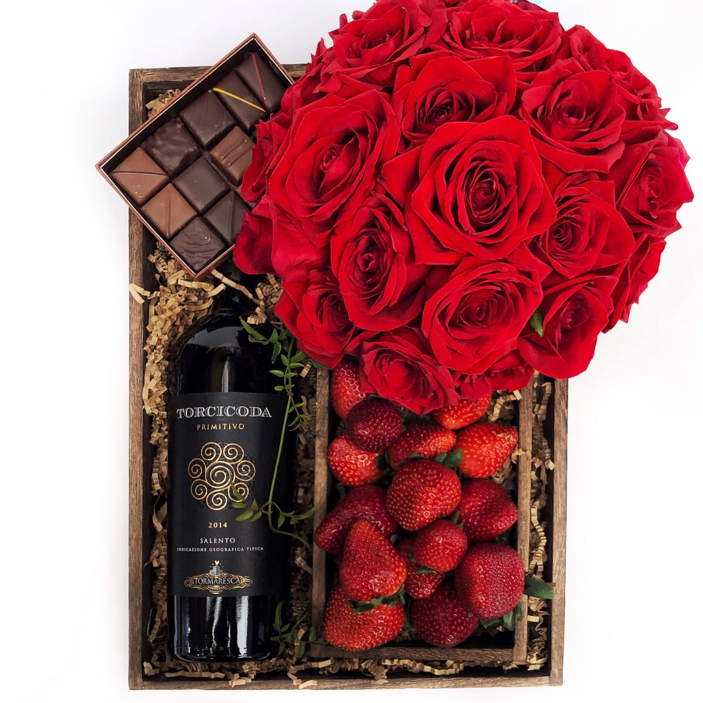 Alaric Flowers | Tosca | Flower Delivery NYC Same Day | Flowers in a box | Florists near me | Valentine Day Delivery | Send Flowers New York -  bottle of Salento Primitivo red vine, a box of assorted chocolates by Maison du Chocolat, a box of fresh strawberries and red roses with a touch of greenery in a glass vase - all in a wooden gift box